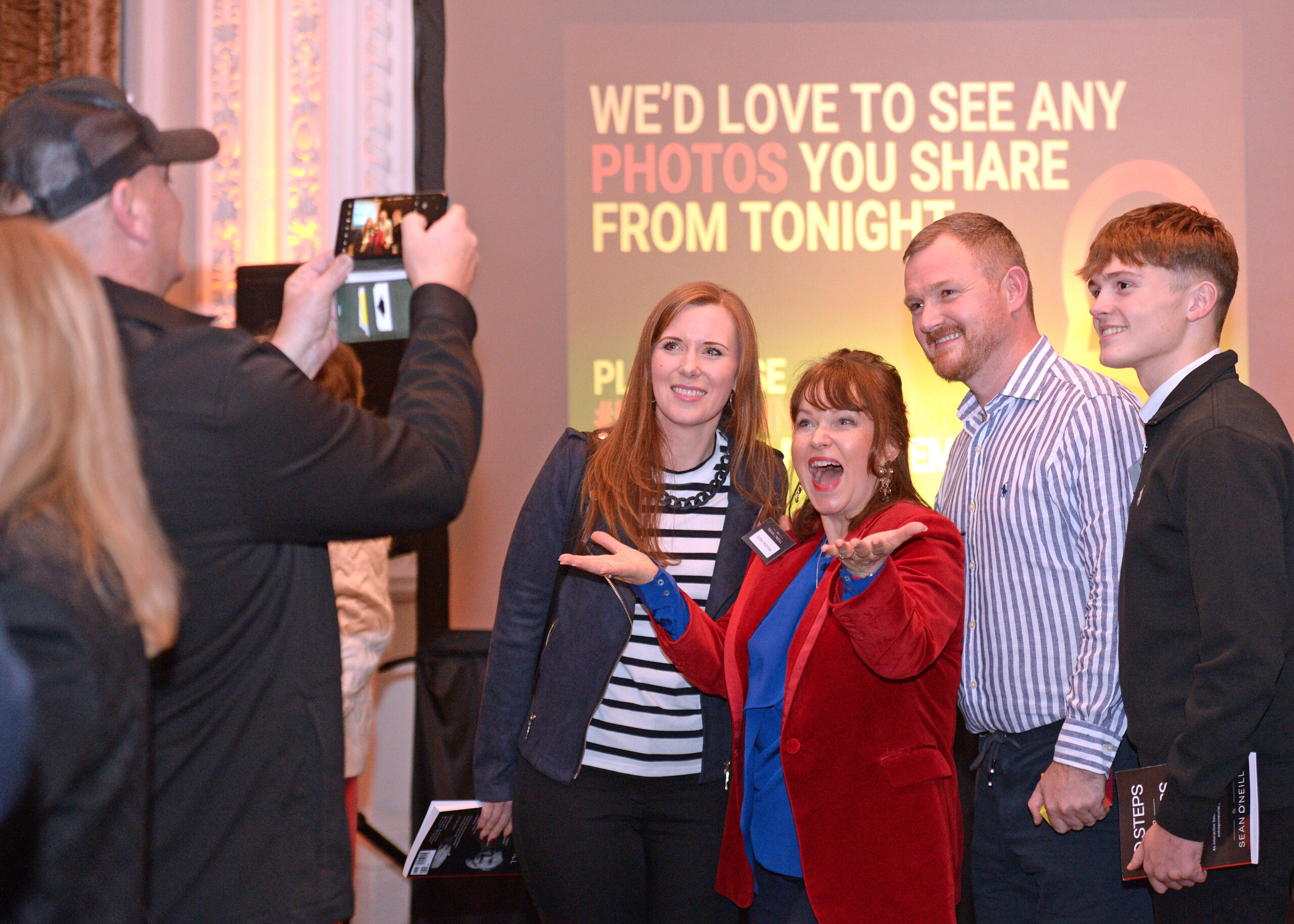 Someone taking a photo of Sean O'Neill and Esther Stanhope at an MSO Event with two other people.